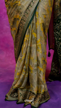 Traditional saree with yellow and green patterns on a pink background
