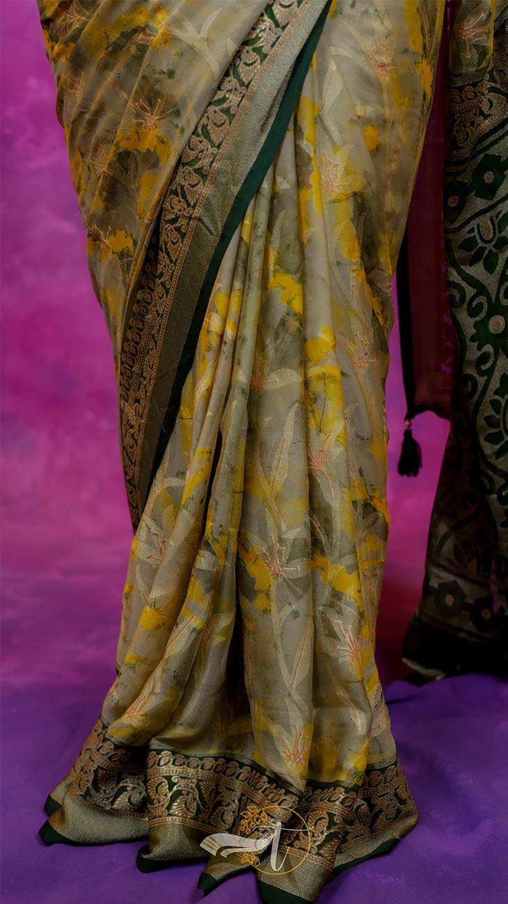 Traditional saree with yellow and green patterns on a pink background