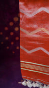 Close-up of a fabric with red and white pattern on a dark background
