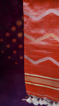 Close-up of a fabric with red and white pattern on a dark background