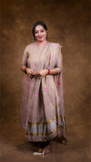 Woman wearing a traditional outfit with a brown background