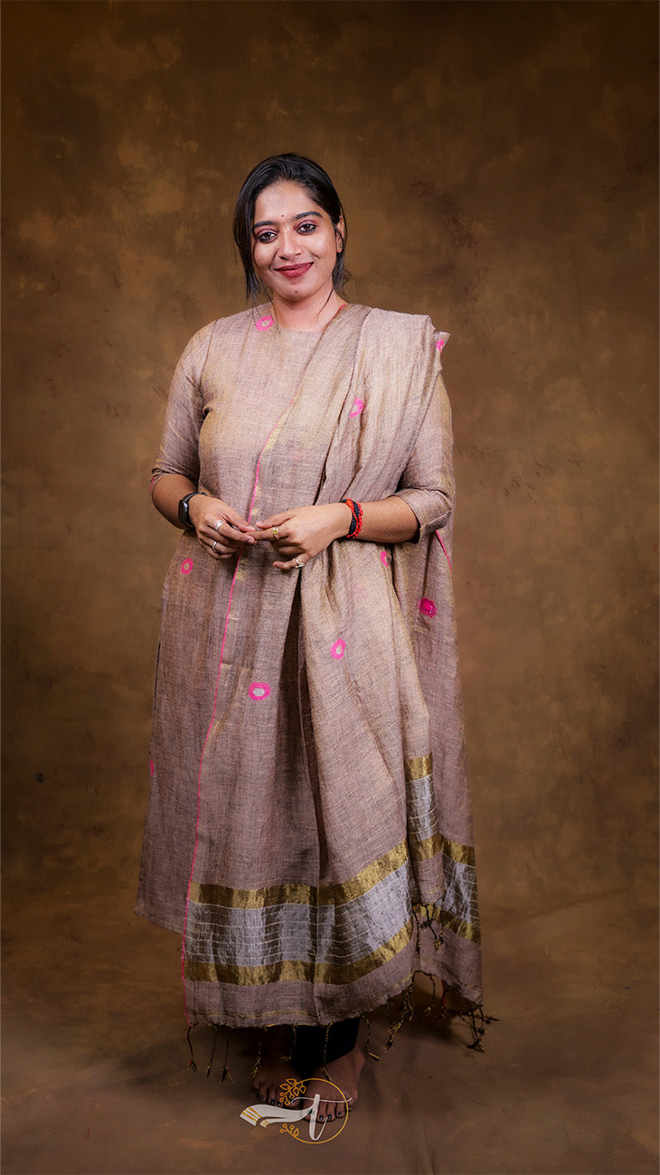 Woman wearing a traditional outfit with a brown background