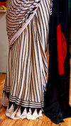 Striped fabric with black and white pattern on a wooden floor