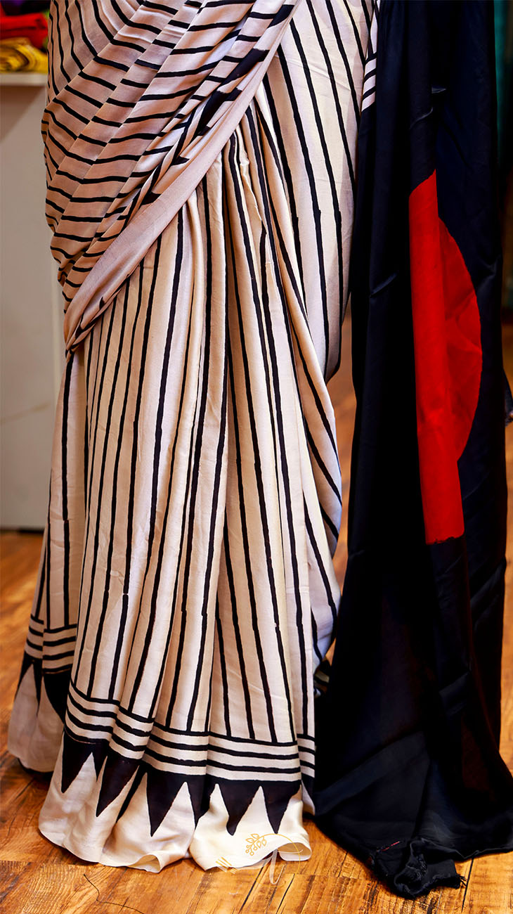 Striped fabric with black and white pattern on a wooden floor
