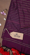 Purple fabric with white stripes and a ' THANVI' tag on a beige background