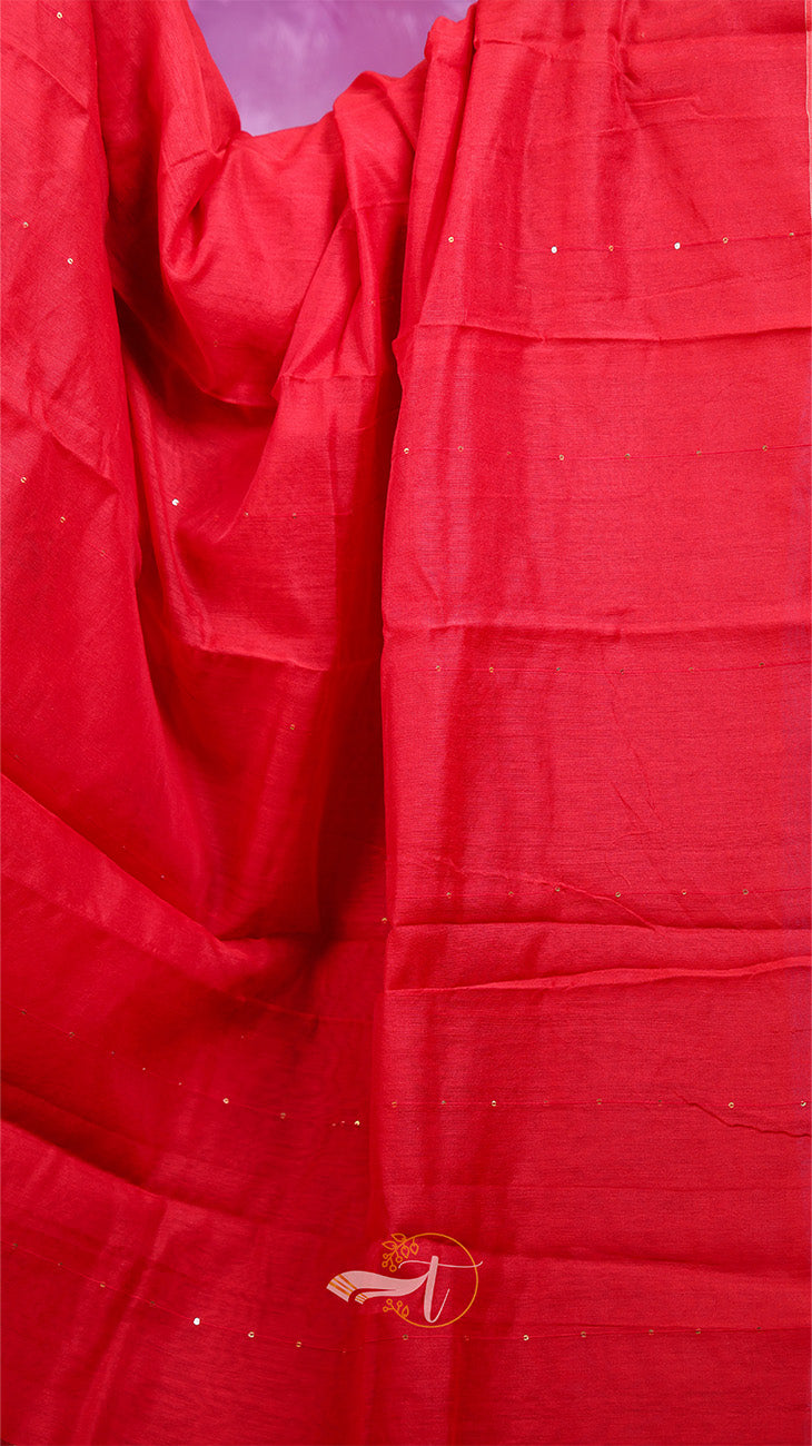 Close-up of red fabric with a visible brand logo in the corner.