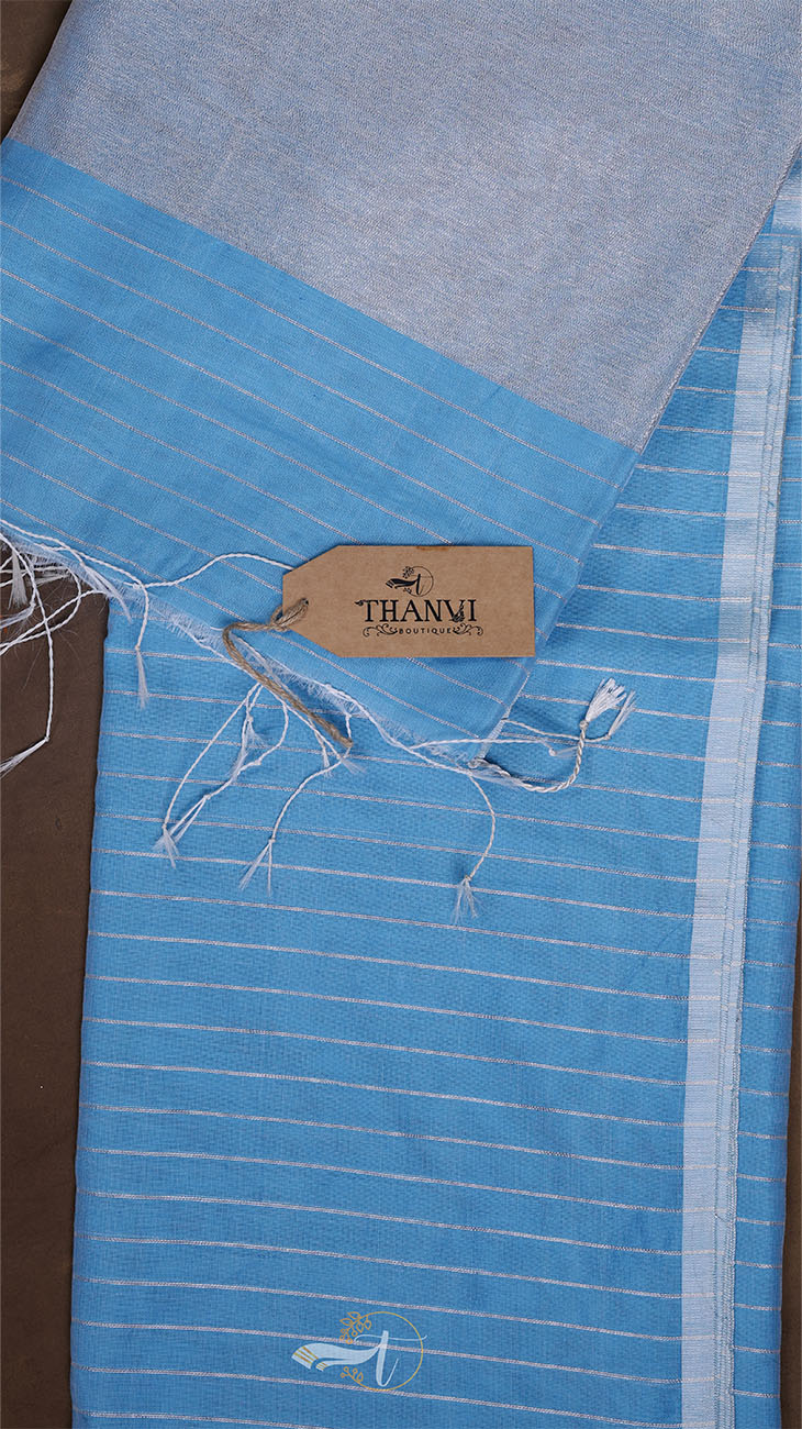 Blue fabric with a visible brand tag on a brown background
