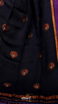 Dark fabric with intricate patterns and embroidery