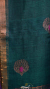 Teal fabric with decorative patterns and a gold border