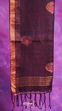 Dark purple scarf with gold patterns and tassels on a purple background