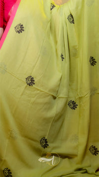 Light green fabric with black floral patterns, possibly a sari or scarf.
