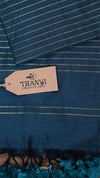 Blue fabric with a 'THANVI' tag in the foreground