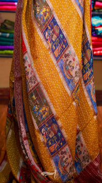 Colorful traditional fabric with intricate patterns on a yellow background