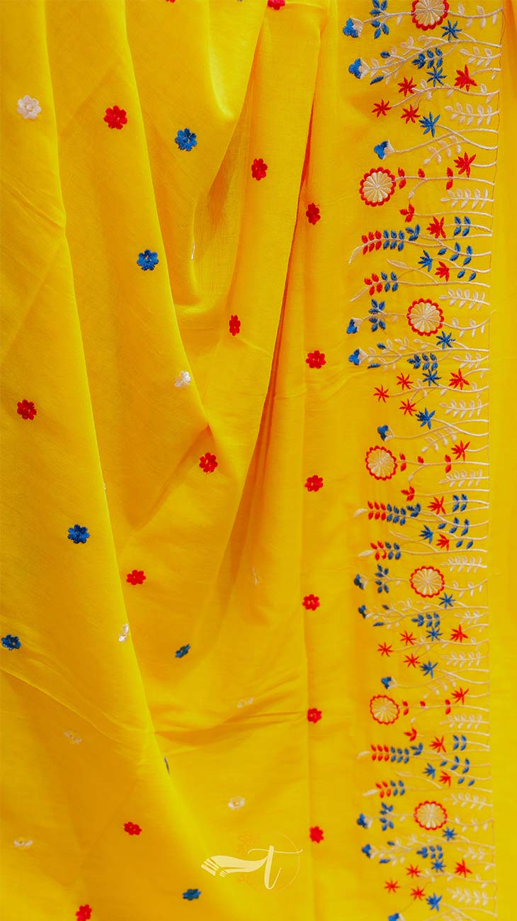 Yellow fabric with colorful floral embroidery