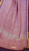 Pink fabric with a subtle pattern on a purple background
