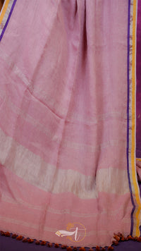 Pink fabric with a subtle pattern on a purple background
