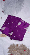 Purple fabric with bird patterns on a textured surface