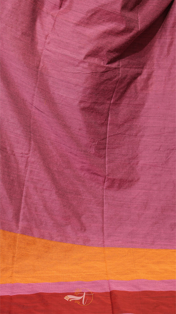 Close-up of a fabric with a pink and orange border, featuring a brand logo.