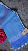 Blue fabric with white trim on a textured surface
