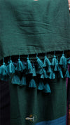 Dark green fabric with tassels on a plain background