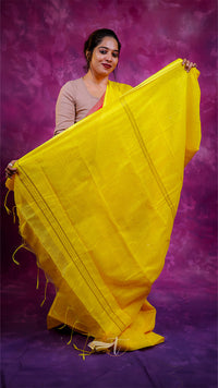 Woman holding a yellow saree against a purple background