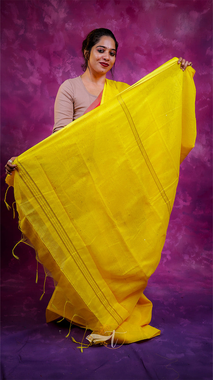 Woman holding a yellow saree against a purple background