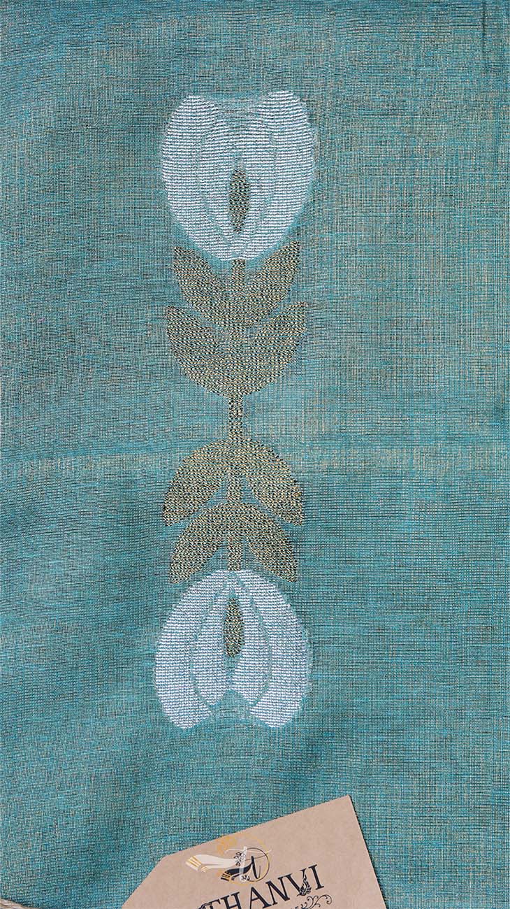 Teal fabric with embroidered floral design, featuring the brand 'Thanvi'.