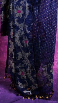 Navy blue embroidered garment with gold details on a purple background