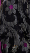 Close-up of a floral patterned fabric with black, gray, and purple colors.