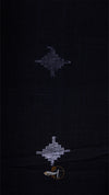Black fabric with embroidered patterns on a dark background
