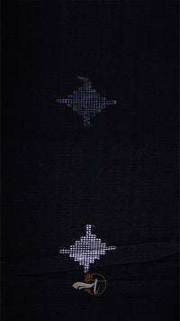 Black fabric with embroidered patterns on a dark background