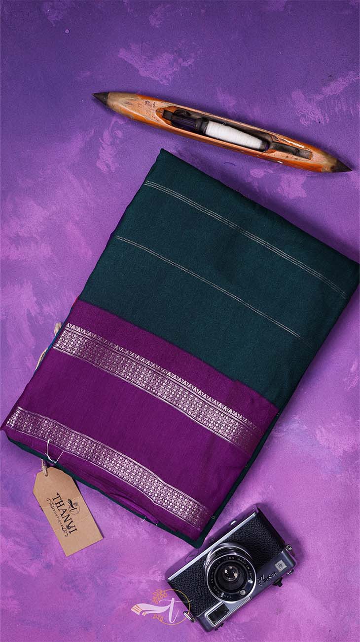 Green and purple saree with a camera and wooden item on a purple background