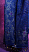 Blue patterned fabric with decorative elements on a purple background