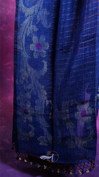 Blue patterned fabric with decorative elements on a purple background