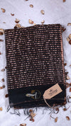 Textured scarf with a brand tag on a light gray background