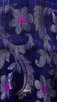Close-up of a floral patterned fabric with purple flowers on a dark background