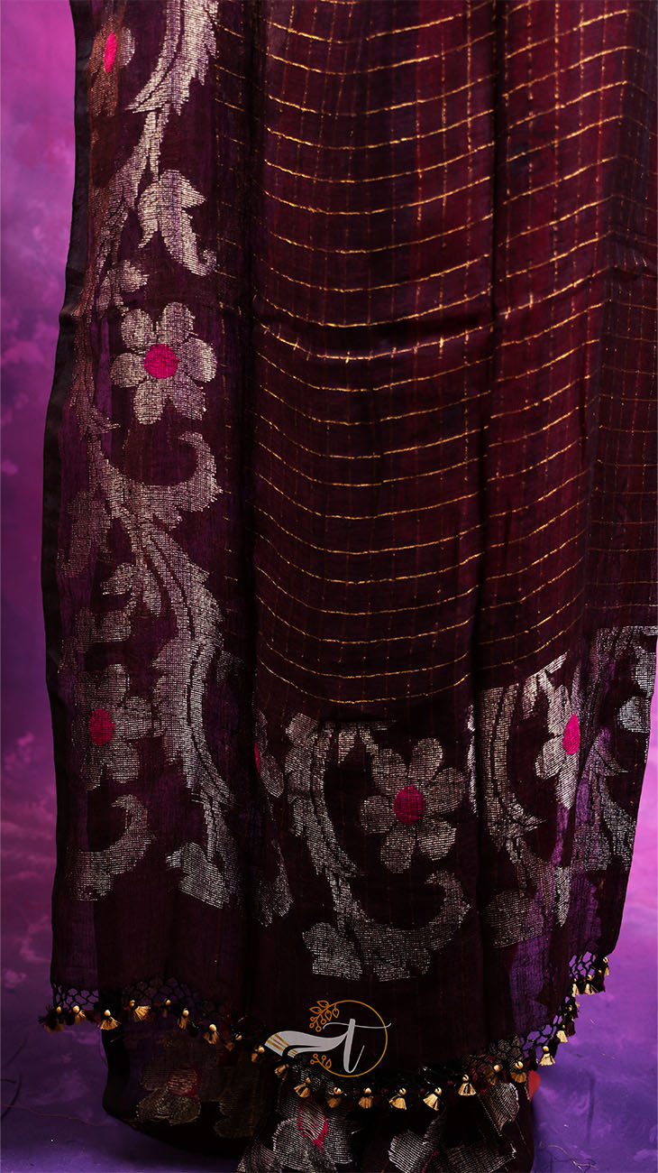 Dark purple embroidered fabric with gold and silver details on a purple background