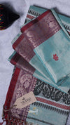 Stack of patterned cloths with a 'THANX' tag on a textured surface