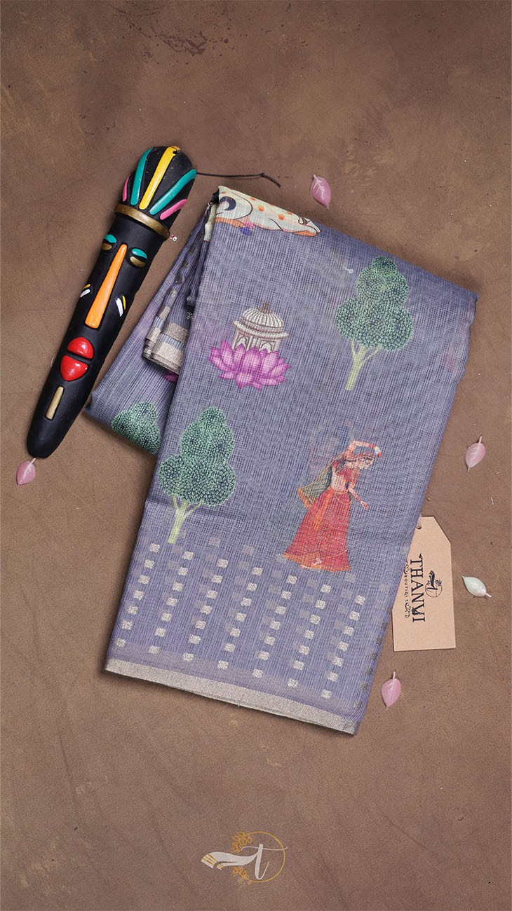 Textile with tree and lotus designs on a brown surface