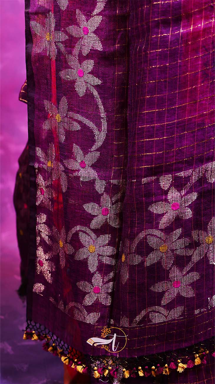 Purple fabric with floral embroidery and decorative elements on a purple background
