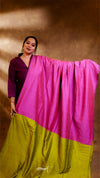 Woman holding a pink and green saree against a brown background