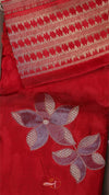 Red fabric with embroidered flowers and patterned border