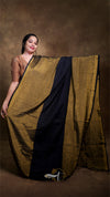 Woman holding a traditional saree with a brown background