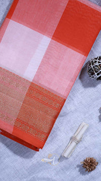 Red and pink checkered fabric with a woven pattern on a textured surface.