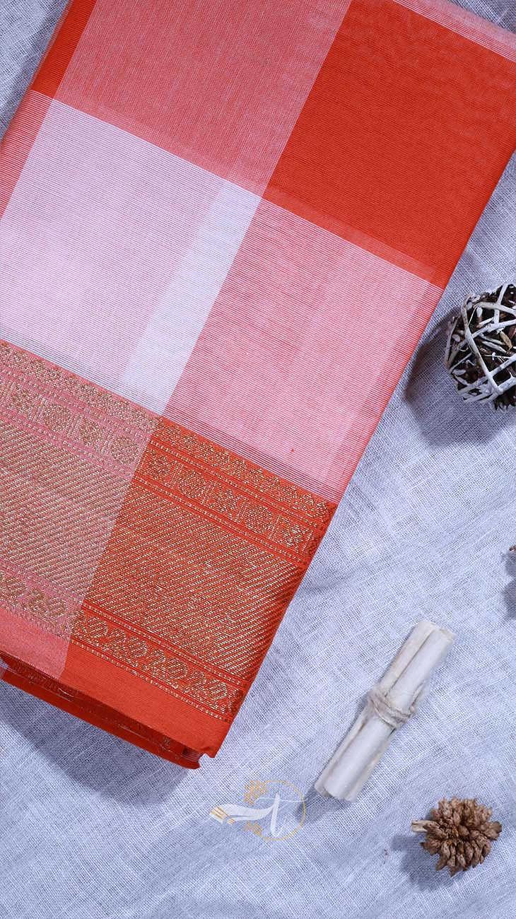 Red and pink checkered fabric with a woven pattern on a textured surface.
