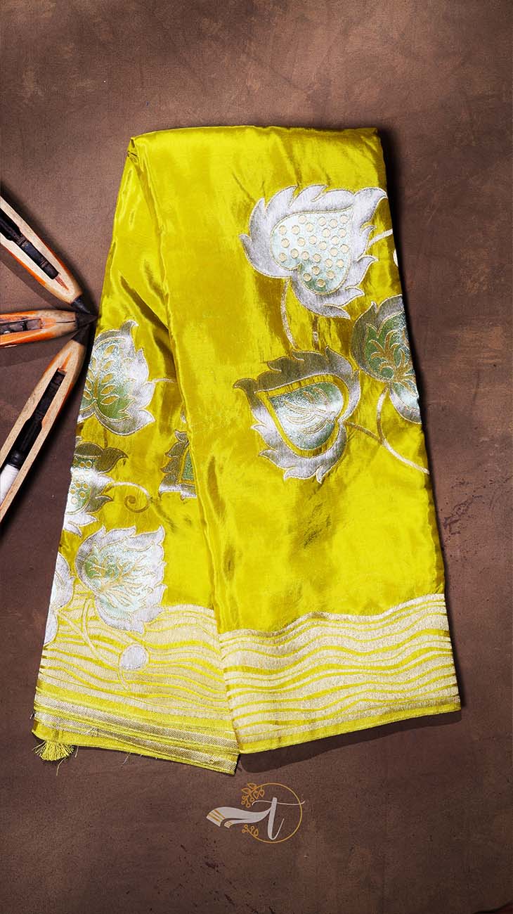 Yellow fabric with floral patterns on a brown background