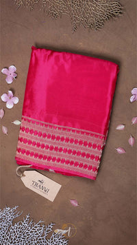 Pink fabric with a patterned border on a brown background, featuring a 'THAVVI' tag.
