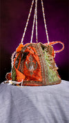 Decorative handbag with intricate designs on a purple background