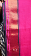 Close-up of a pink fabric with black and orange stripes, featuring a brand logo.