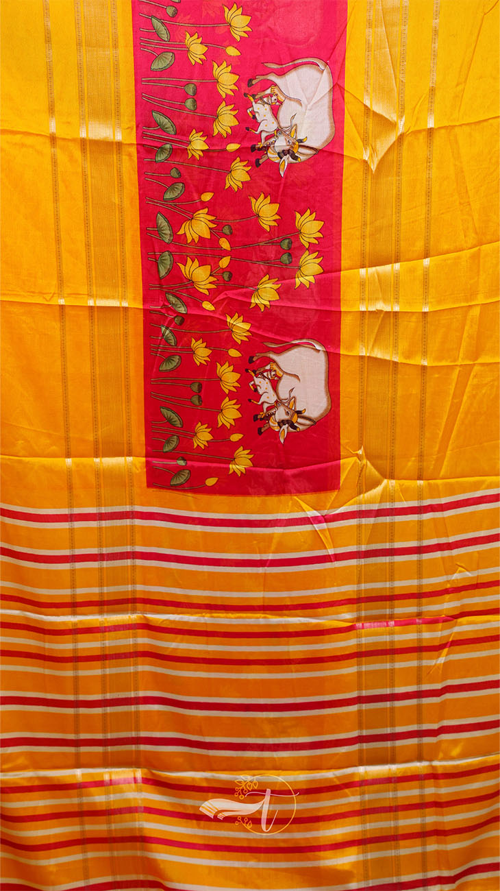 Yellow fabric with red border and cow design, featuring the brand 'Bajrang'.
